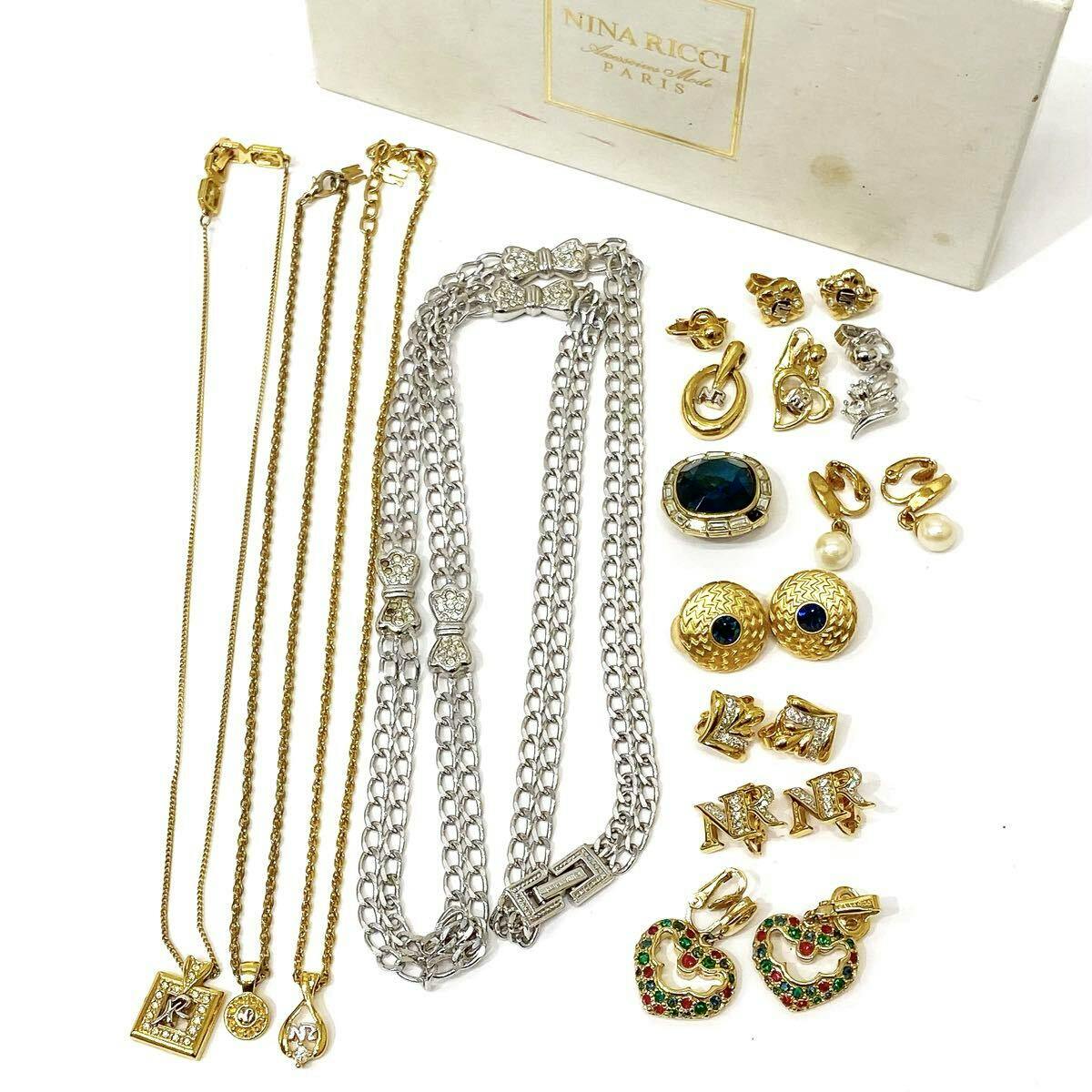 NINA RICCI necklaces and assorted earrings arranged with a Nina Ricci box on a white background.