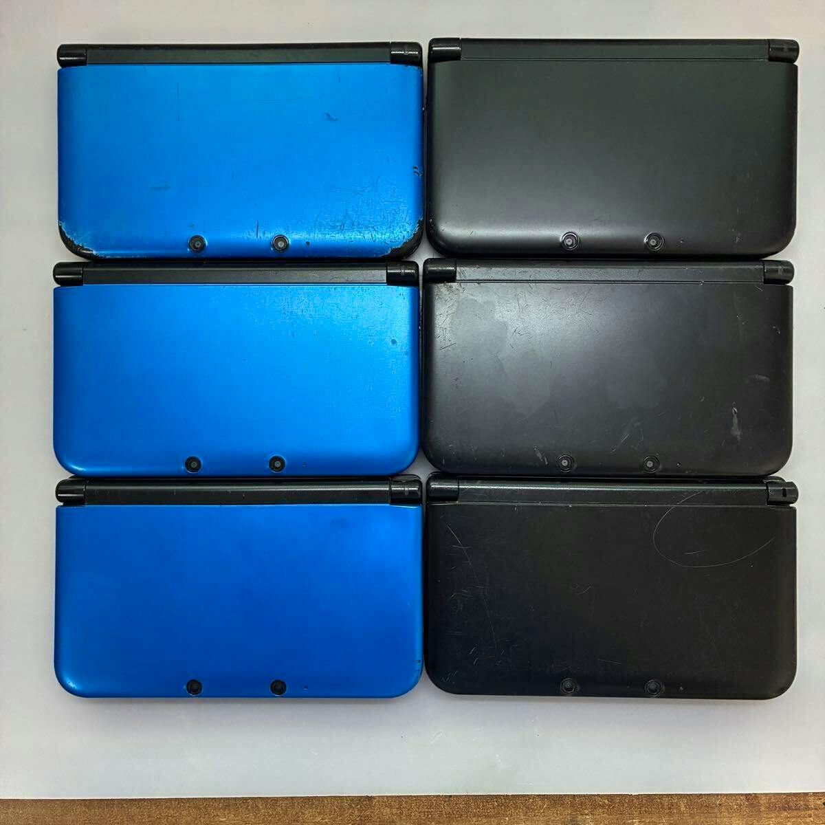 Six Nintendo 3DS LL handheld consoles in blue and black, shown closed and arranged on a flat surface.