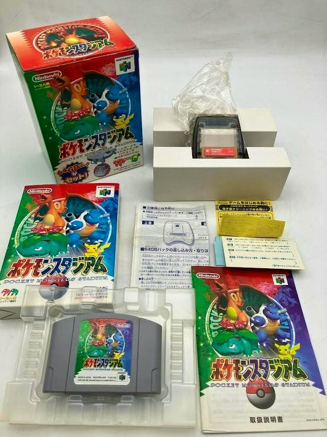 Nintendo 64 Pokémon Stadium 64GB pack set laid out, showing the game cartridge, original box, manuals, and inserts.