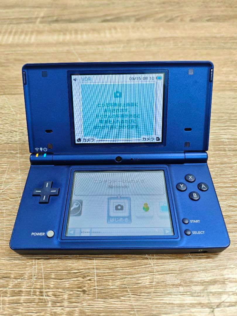 Open metallic blue Nintendo DSi handheld console showing both screens and front controls.