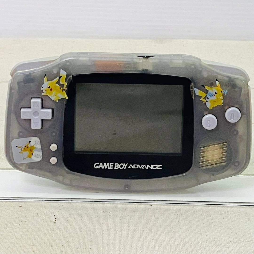 Front view of the milky-blue translucent Game Boy Advance handheld showing the screen, D-pad, A/B buttons, speaker, and Pikachu stickers.