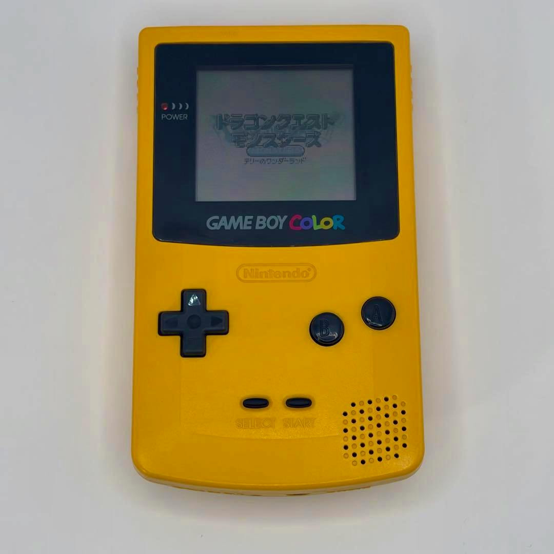 Front view of a yellow Game Boy Color console (CGB-001) with the screen on and buttons visible.