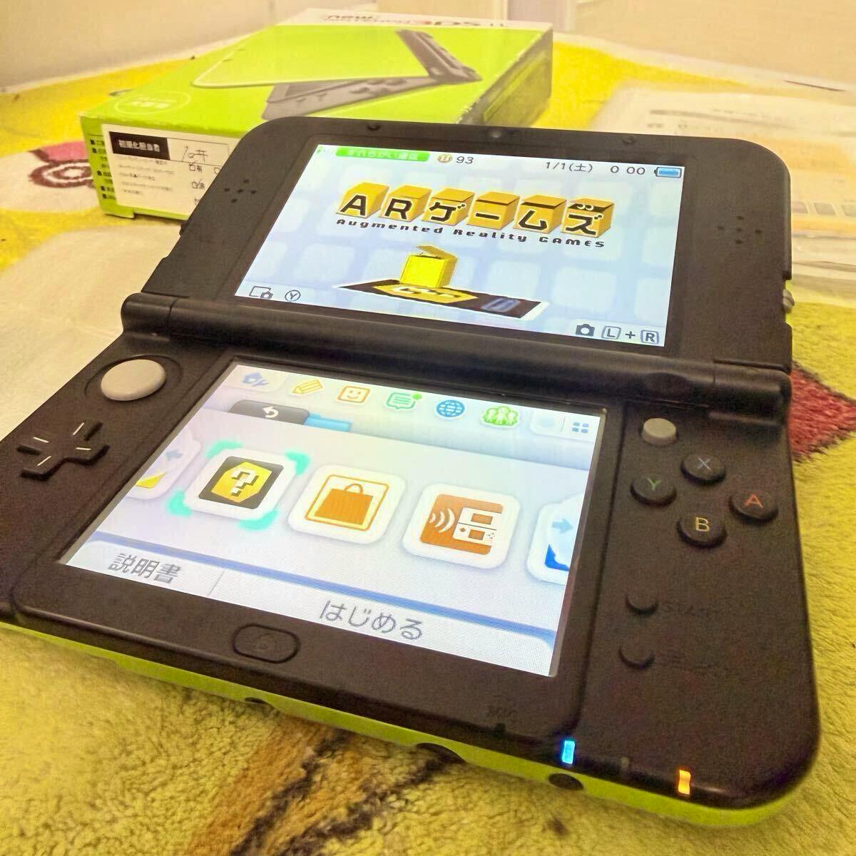 Open New Nintendo 3DS LL handheld console with black interior and green outer shells, screens turned on showing the home menu.