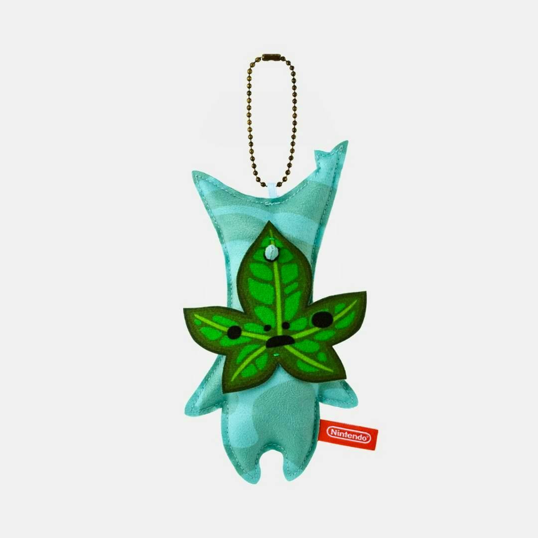 Nintendo TOKYO Korok mascot plush keychain with a green leaf face on a blue-green body, a ball chain, and a red Nintendo tag.
