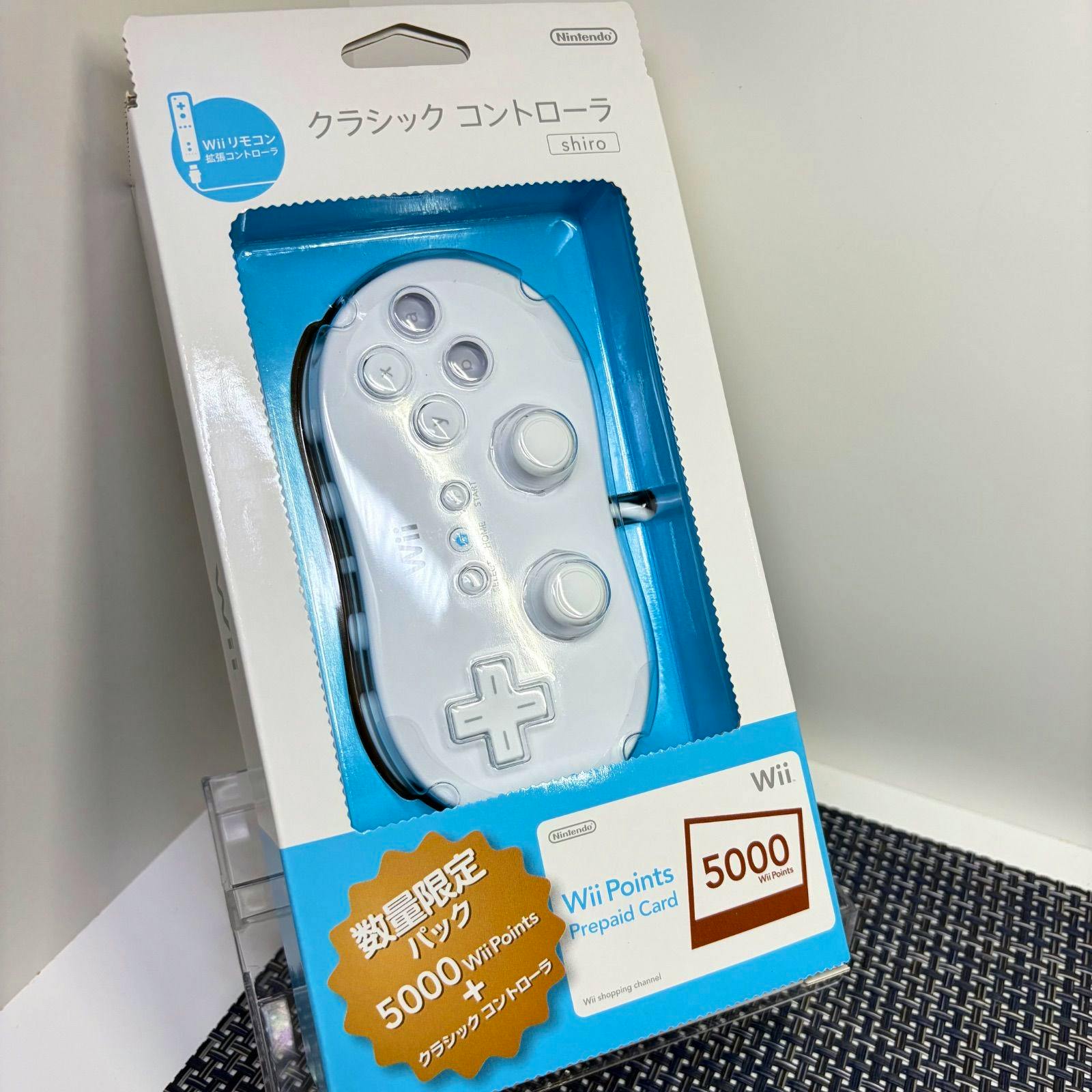 White Nintendo Wii/Wii U Classic Controller shown inside its original retail box visible through the plastic window.