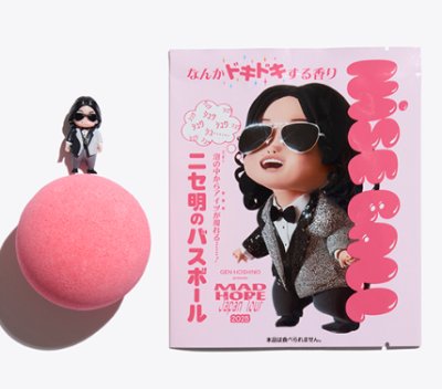 A pink bath ball next to its boxed packaging showing a cartoon character wearing sunglasses and a small figurine.
