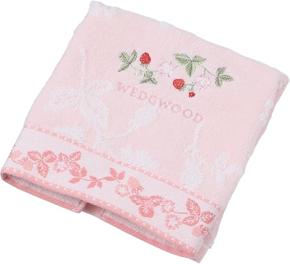 Folded pink hand towel (face towel) with floral embroidery and a visible "WEDGWOOD" logo.