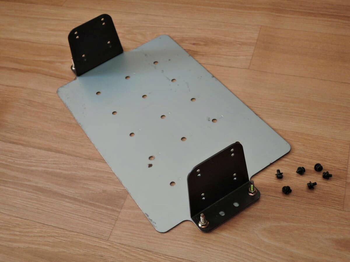 CD changer mounting bracket for Nissan S14 Silvia shown on a wooden floor with mounting screws.