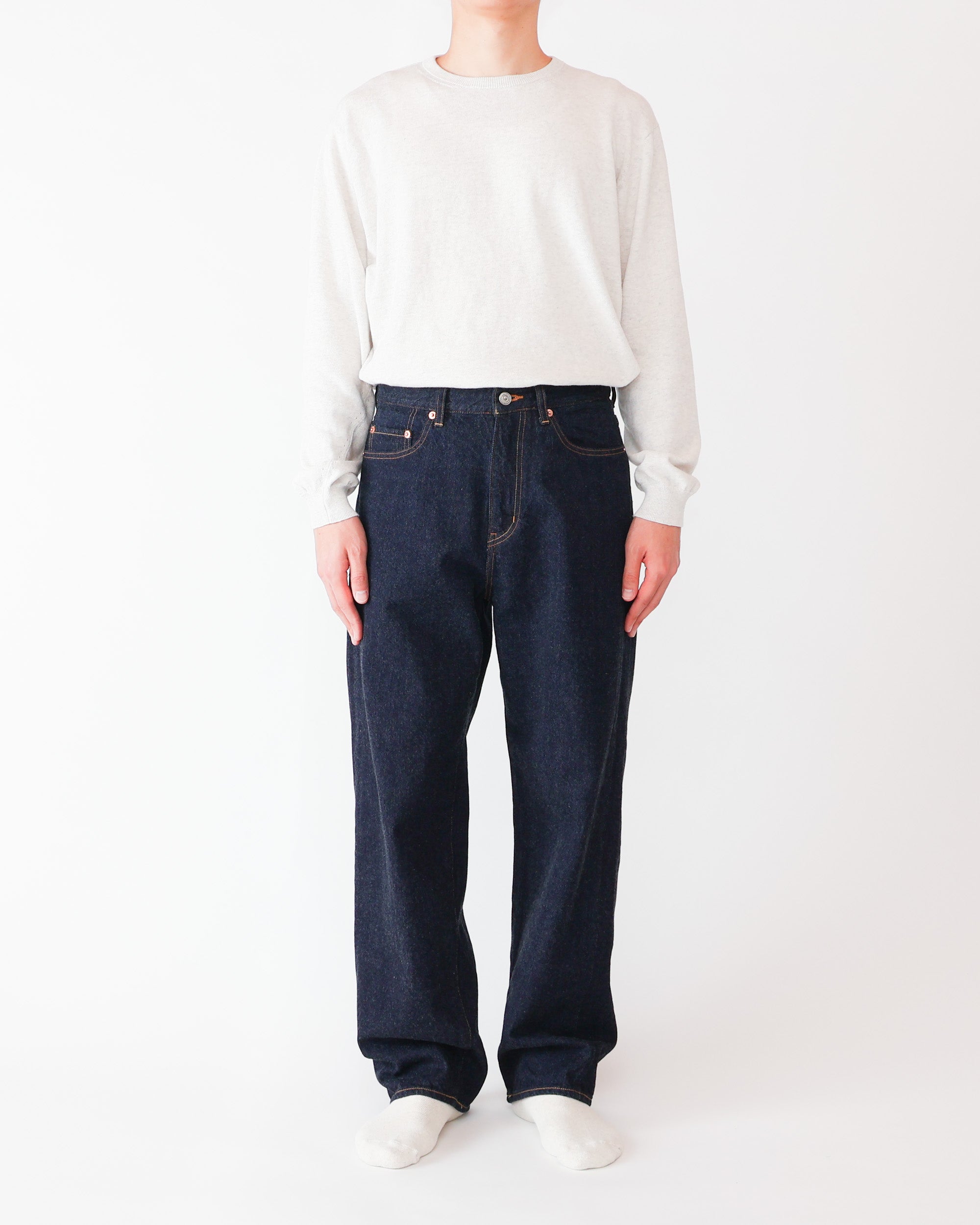Front view of a model wearing No.13 Wide Straight men's black cotton pants against a white background.