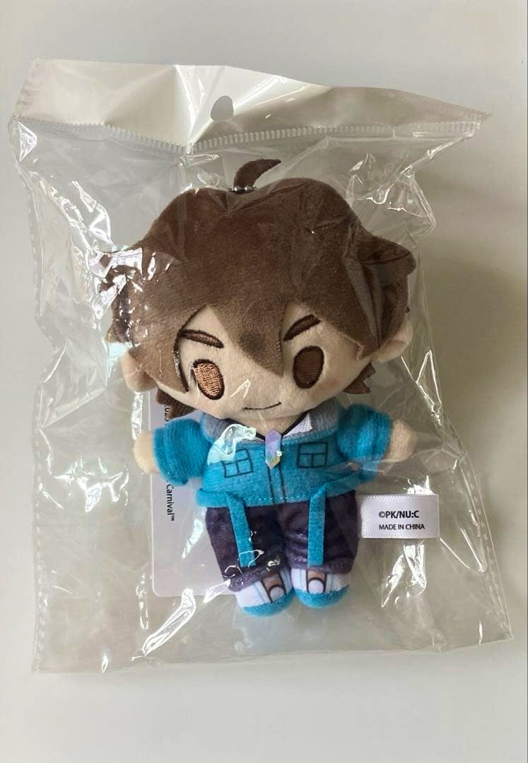 Photo of the nuカーニバル ドンキ エイト plush toy inside clear plastic packaging, showing the brown-haired chibi plush wearing a blue jacket.