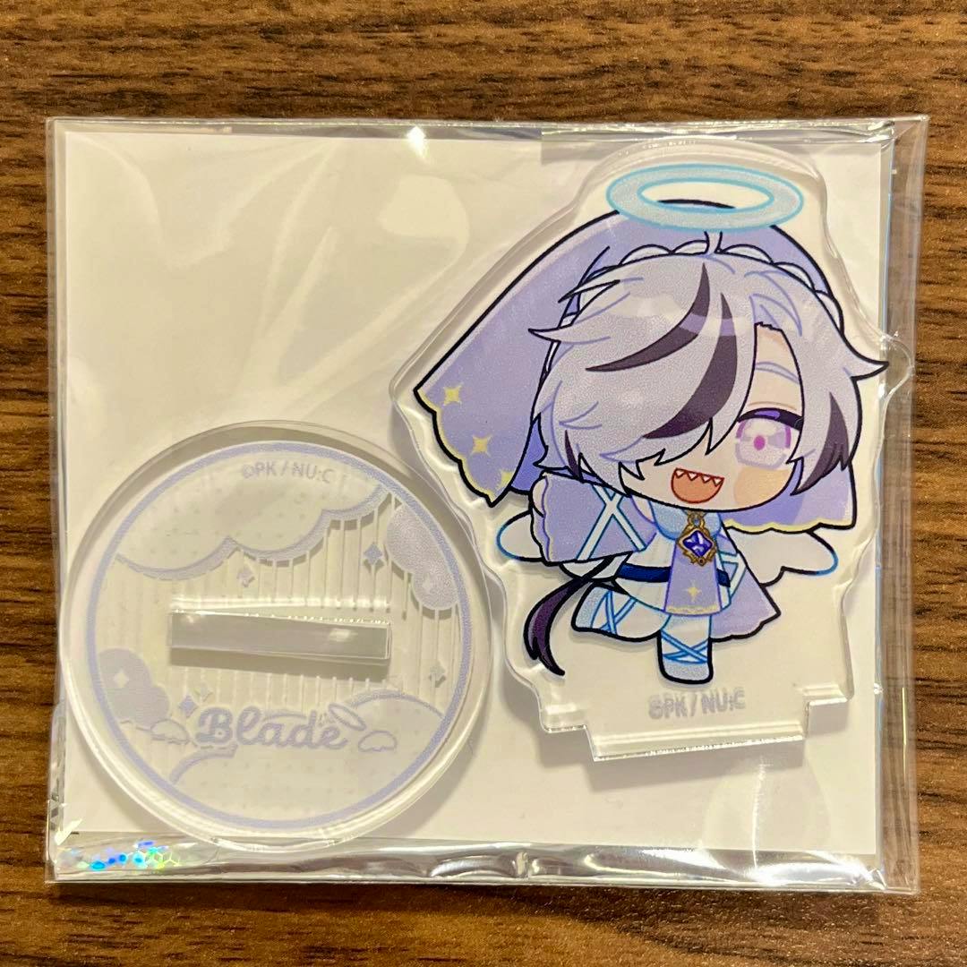 Packaged acrylic decorative stand (Blade) showing the chibi character figure and its round base on a wooden surface.
