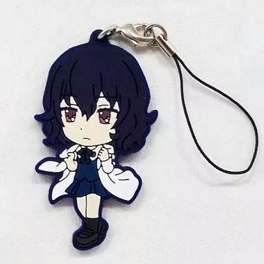 Rubber character strap of 布束砥信 showing a chibi dark-haired girl charm with attached cord on a white background.