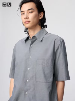 Male model wearing a grey boxy short-sleeve shirt with a chest pocket.
