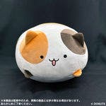 Round cat plush toy with orange and brown patches and a smiling face on a black backdrop.