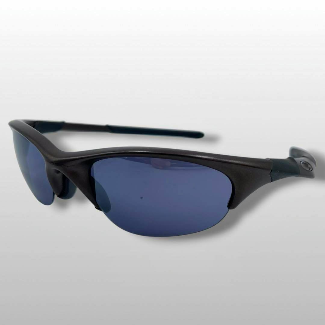 OAKLEY black sports sunglasses with dark blue lenses shown at an angle on a light background.