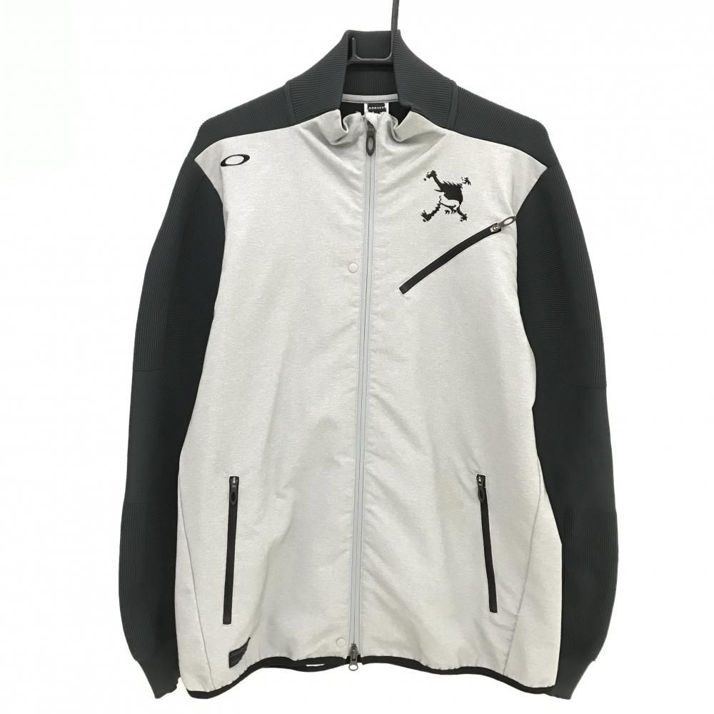 Oakley light-gray and dark-gray men's knit jacket shown front on a hanger.