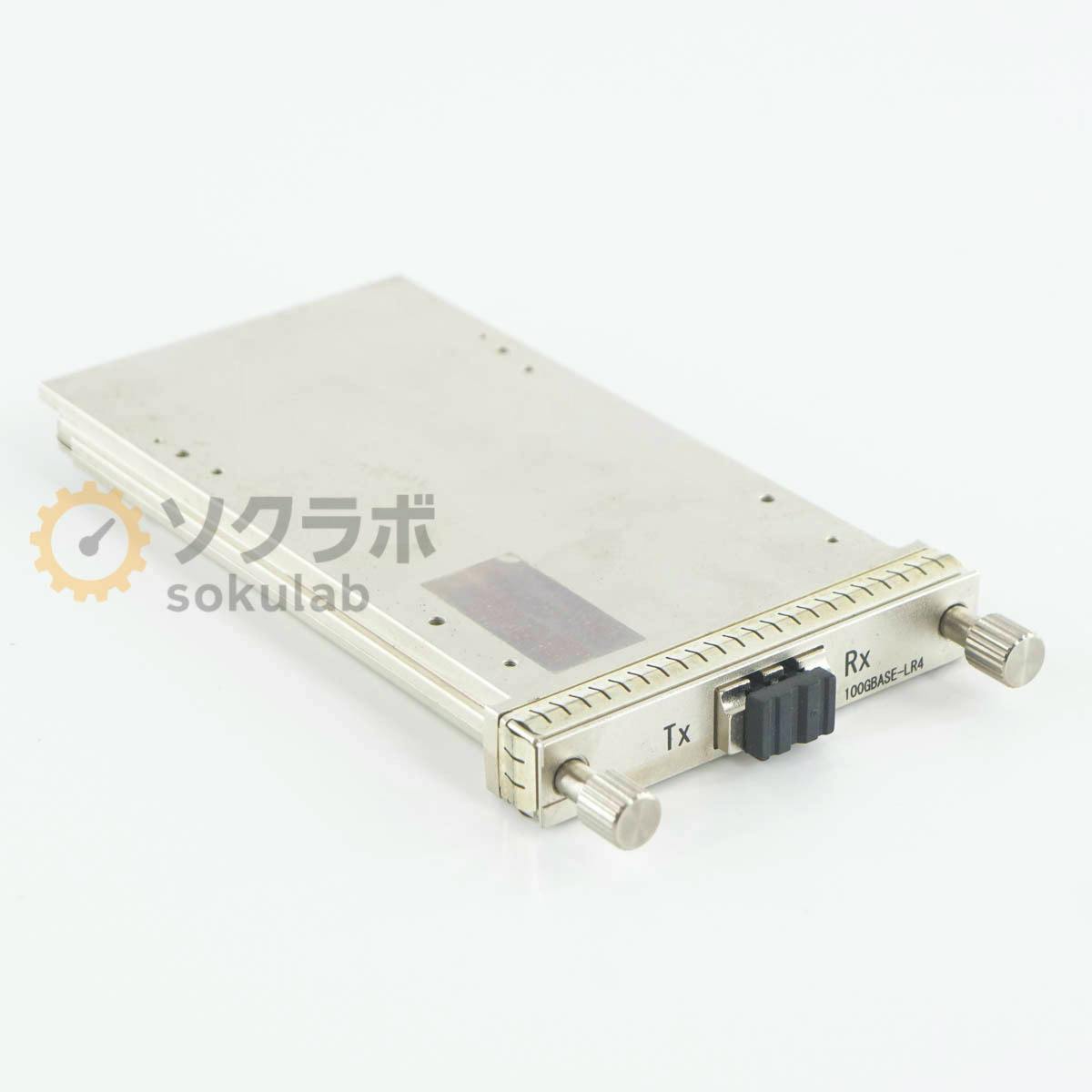 Silver optical transceiver module shown at an angle on a white background, with front ports labeled "Tx", "Rx" and "100GBASE-LR4".