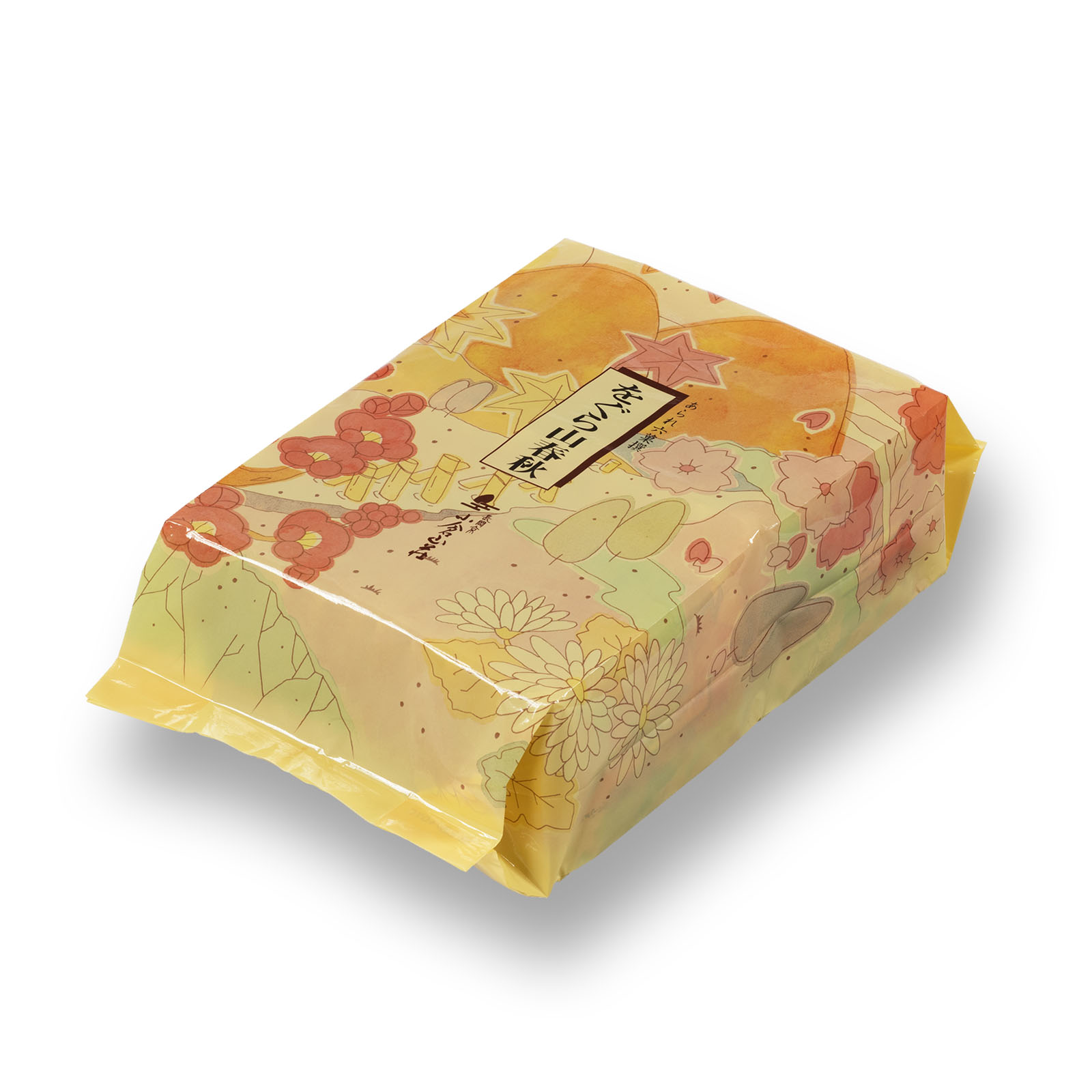 A decorative yellow-orange patterned refill bag of をぐら山春秋 rice crackers.