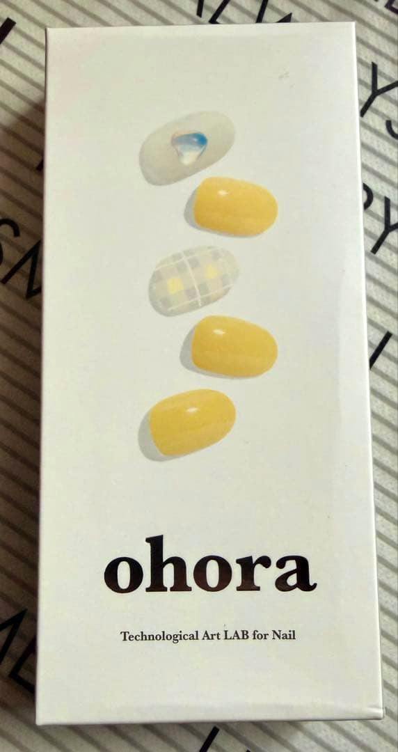 Photo of the ohora N Butter nail sticker product box showing five yellow and patterned nail tips on the front.