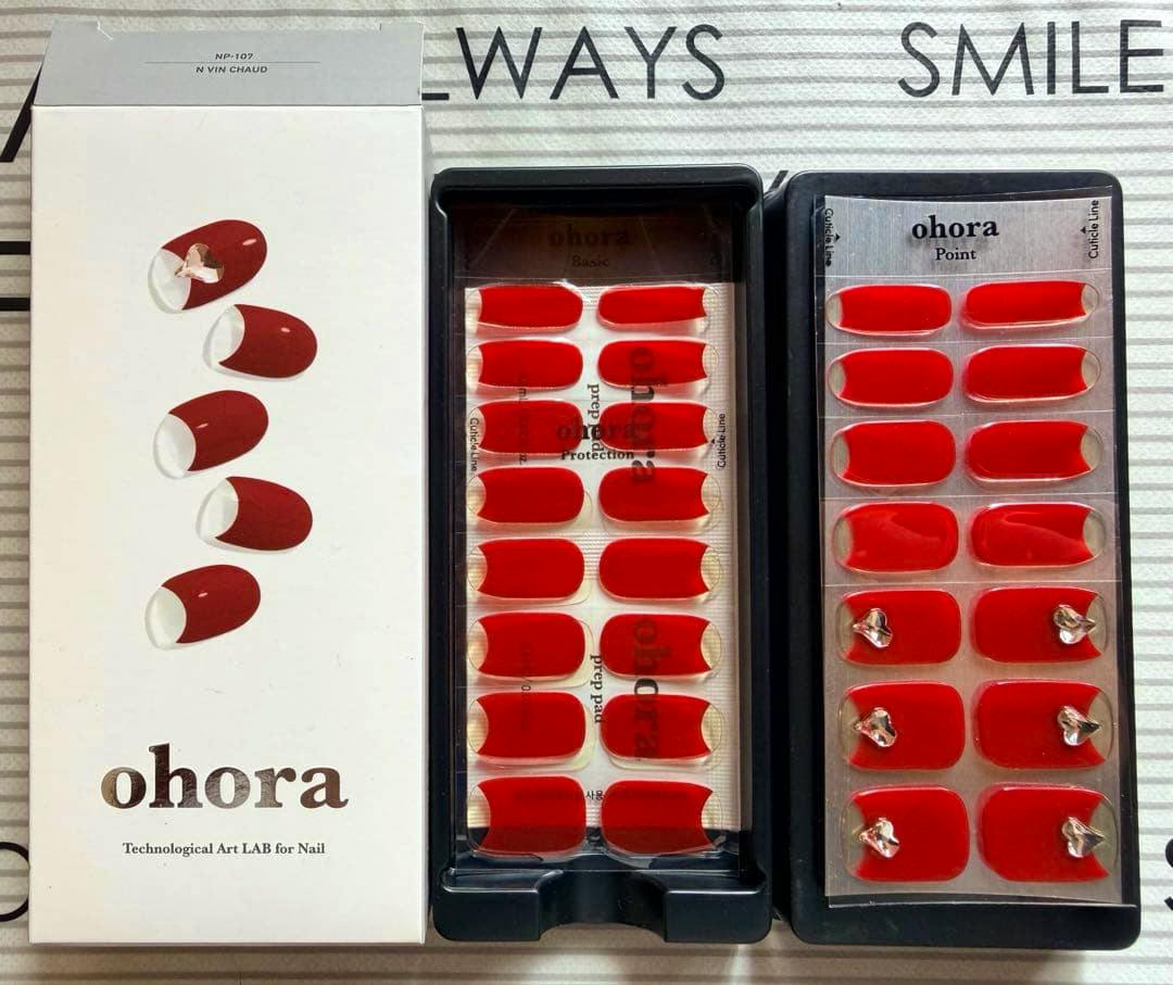 Photo of the ohora N Vin Chaud nail sticker set showing the product box and two trays of red nail stickers.