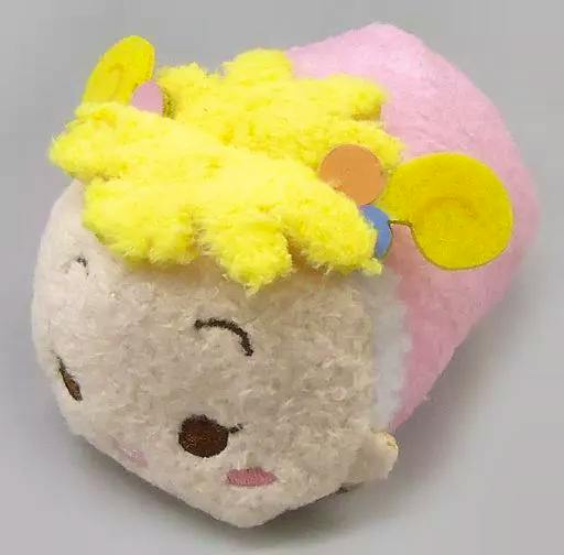 Pink and yellow plush mascot badge (Hana-chan) shown at an angle with embroidered eyes, blush marks, and fluffy yellow hair.