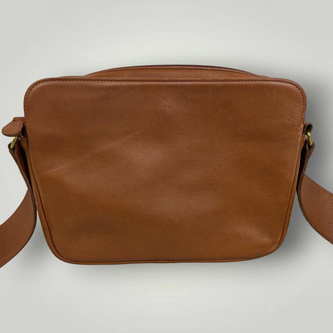 Front view of the brown leather shoulder bag from the listing, showing the bag's smooth leather surface and strap attachments.