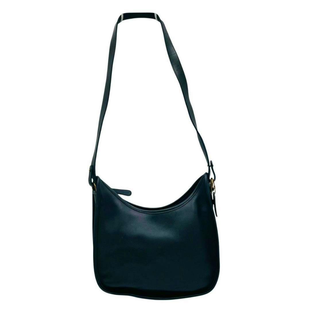 Navy leather Old Coach one-shoulder bag shown full-length with its long strap against a white background.
