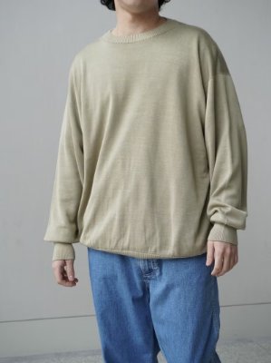 Person wearing the Olde H & Daughter silk crew neck sweater in ginger ale, shown from mid-thigh up against a neutral wall.