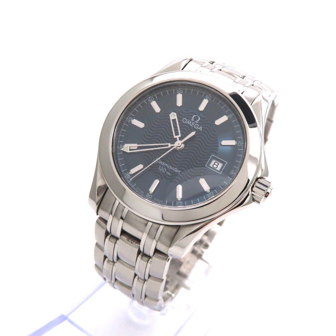 Stainless steel Omega Seamaster 120 men's wristwatch with a blue wave-pattern dial and date window at 3 o'clock shown on a display stand.