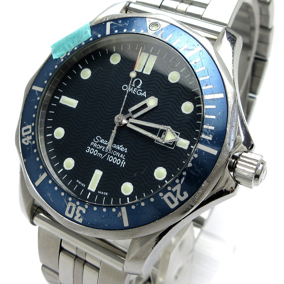Close-up of an Omega Seamaster 300 Professional (model 2541.80) men's stainless-steel wristwatch with blue rotating bezel, wave-pattern black dial, and metal bracelet.