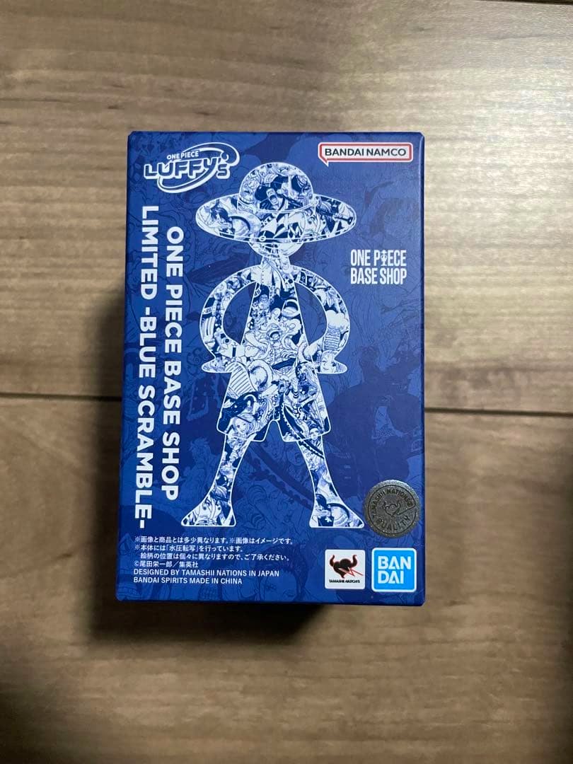 Front of the boxed ONE PIECE BASE SHOP limited Luffy figure showing blue packaging and branding.