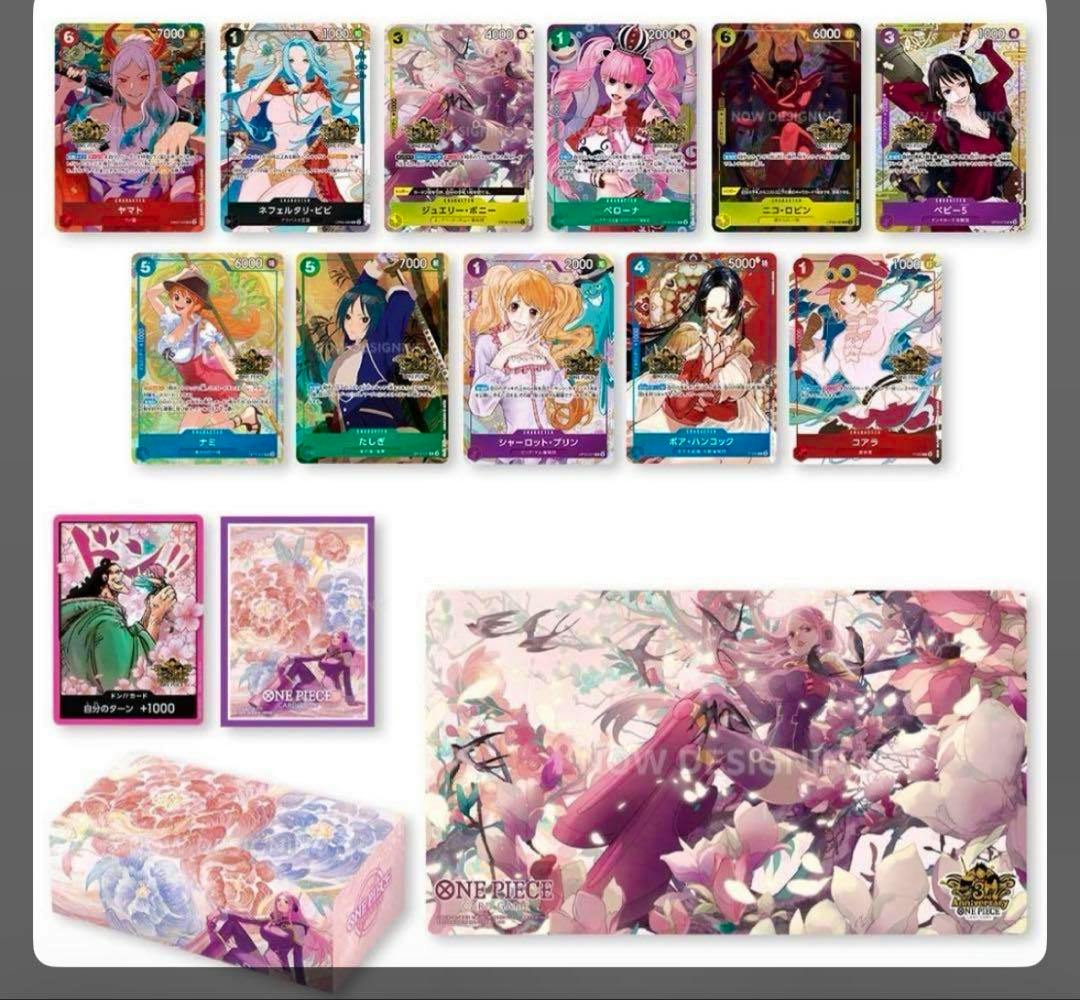 Display of One Piece trading cards arranged in rows with matching card sleeves, a floral deck box, and a playmat from the 3rd anniversary China version set.