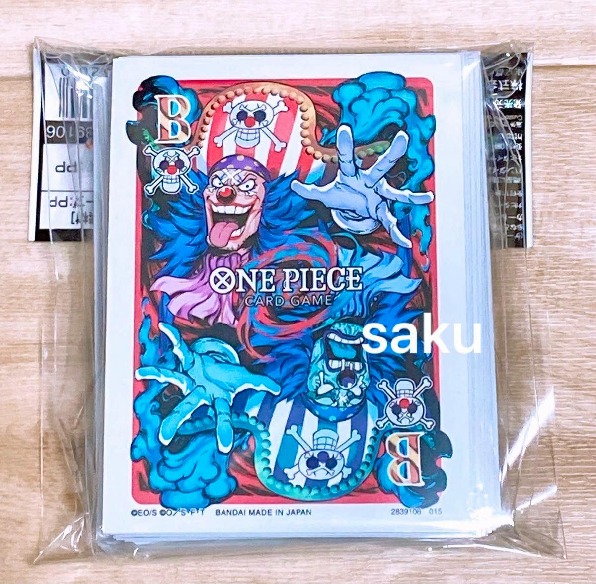 Sealed pack of ONE PIECE Card Game limited edition sleeves showing Buggy artwork on a wooden surface.