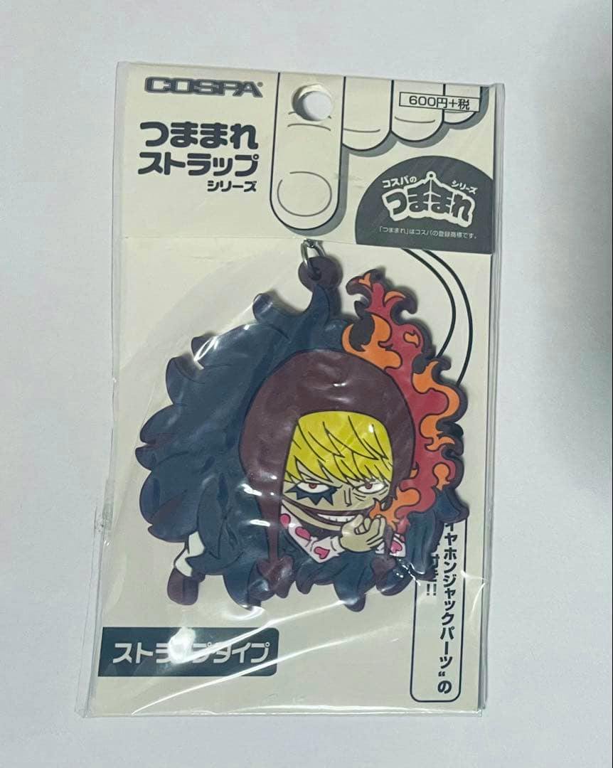 Front view of the ONE PIECE コスパ つままれストラップ ロシナンテ（コラソン） plastic keychain in its original packaging, showing the character charm.