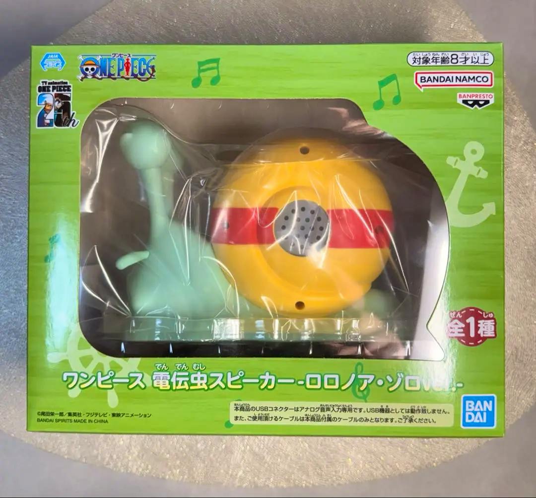 Packaged One Piece 電伝虫 (Den Den Mushi) speaker Roronoa Zoro version visible through the green windowed box.