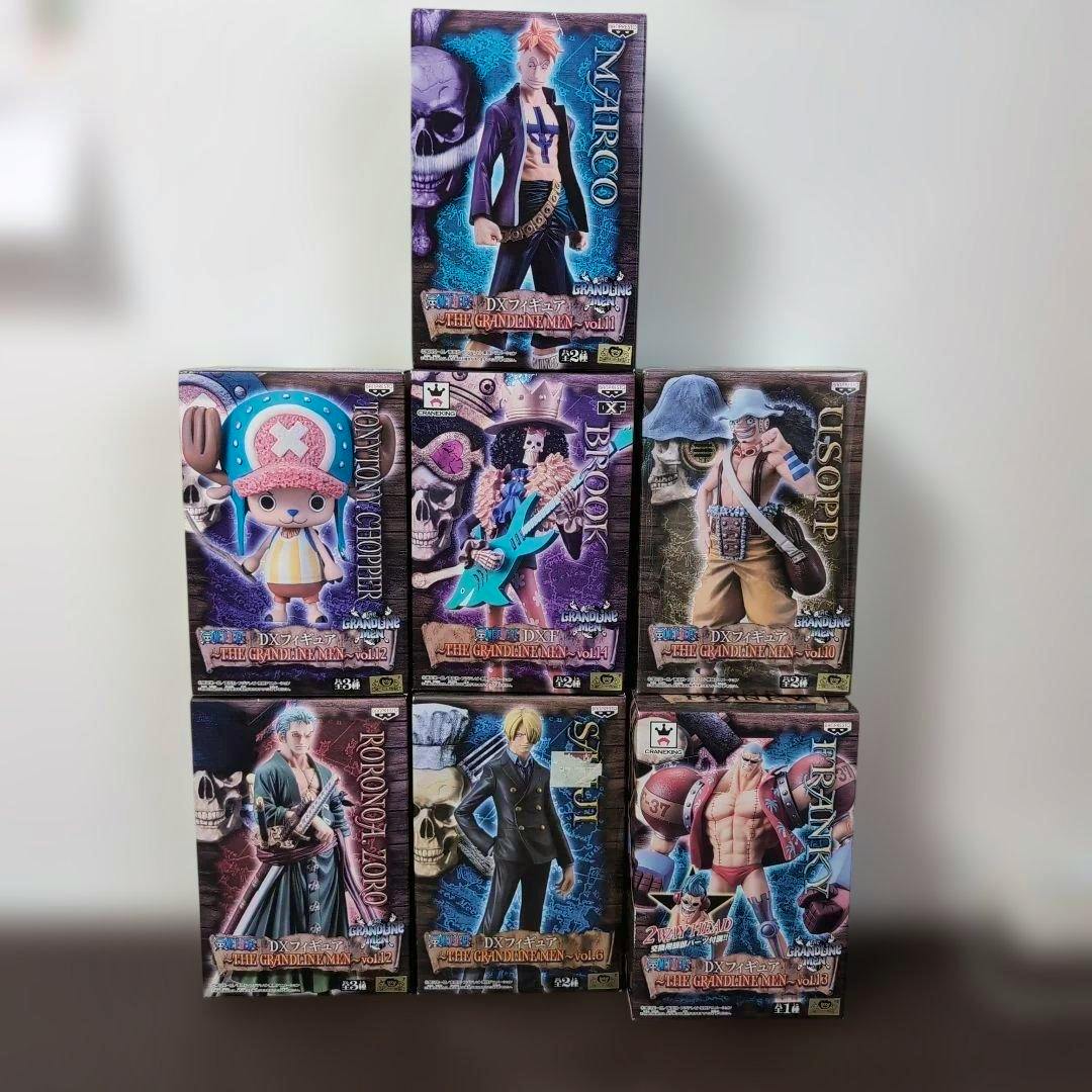 Seven boxed One Piece DX Figure THE GRANDLINE MEN figures arranged in a pyramid.