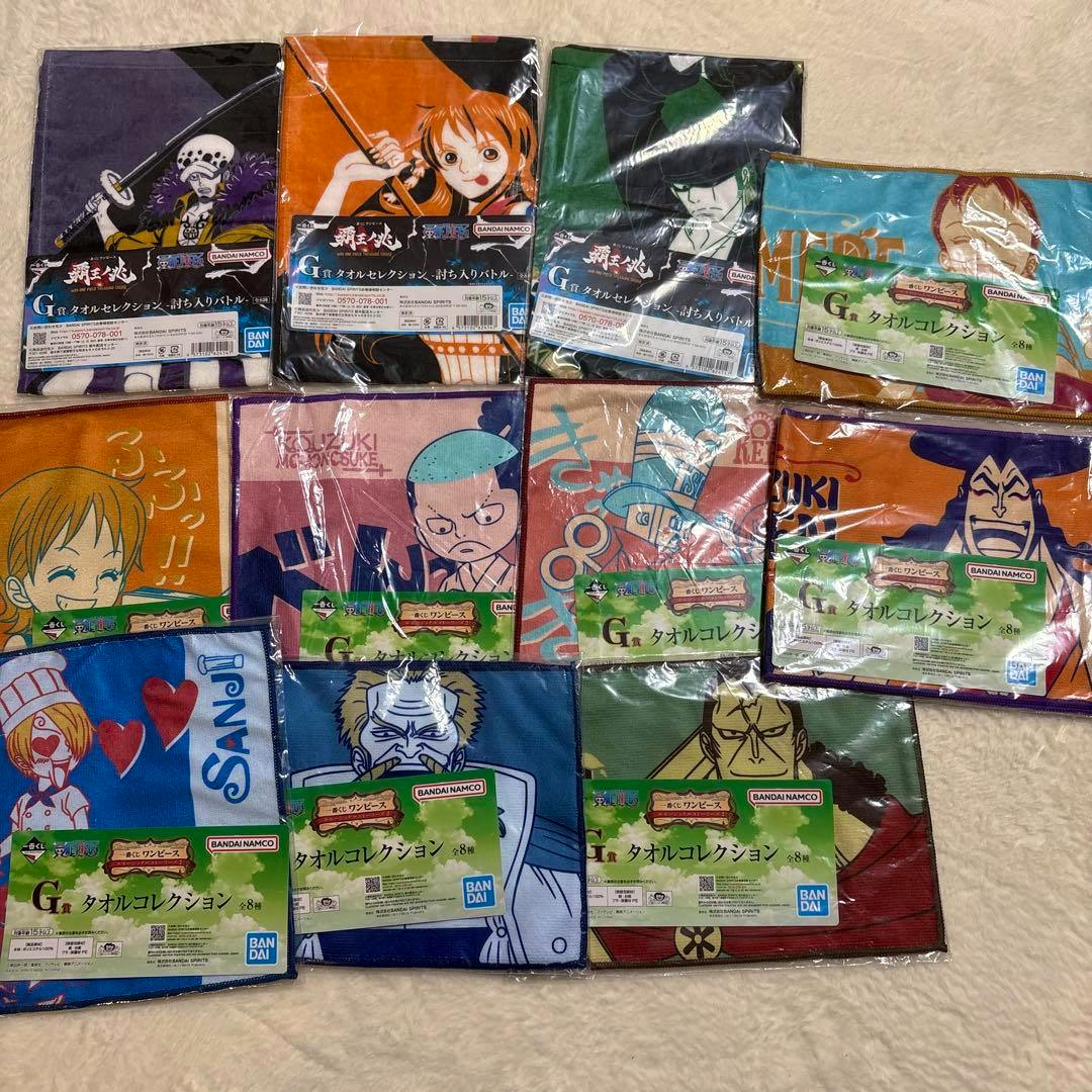 Packaged One Piece G-prize character-design towels arranged in a grid on a light surface.