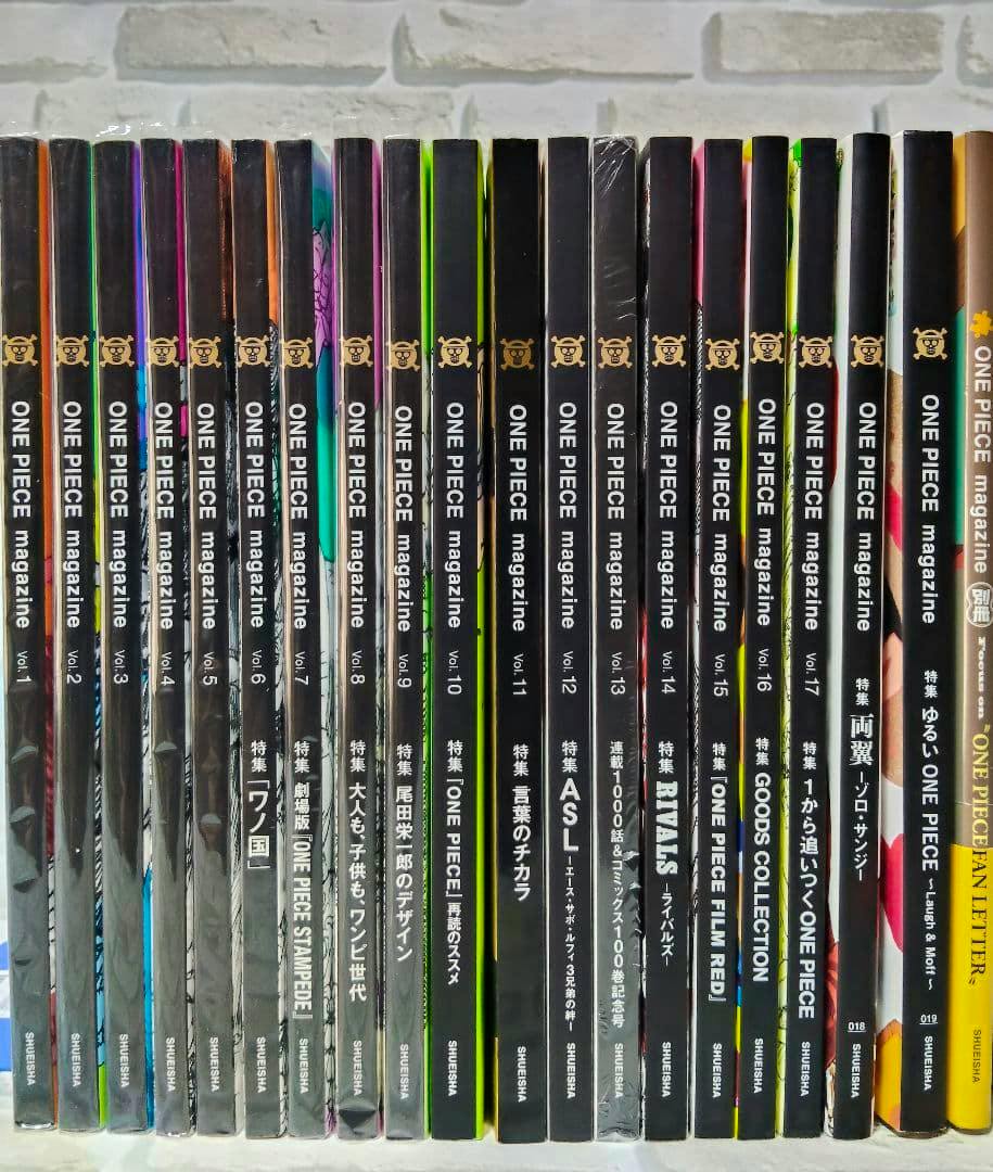 Front-on photo of 20 ONE PIECE magazine issues standing side-by-side showing their spines.