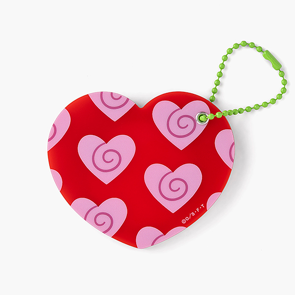 Closed heart-shaped compact mirror with a red surface patterned with pink hearts and an attached green bead chain on a white background.
