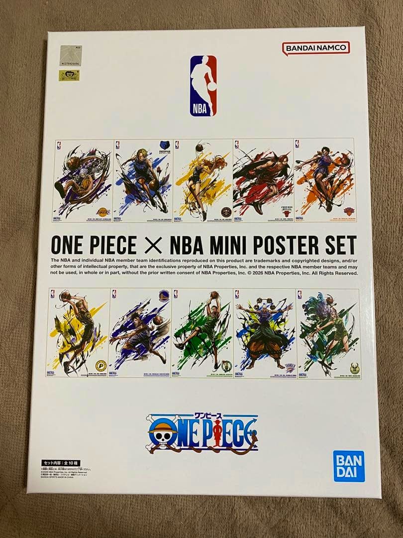 Photo of the unopened ONE PIECE × NBA mini poster set box showing thumbnail poster artwork and branding.
