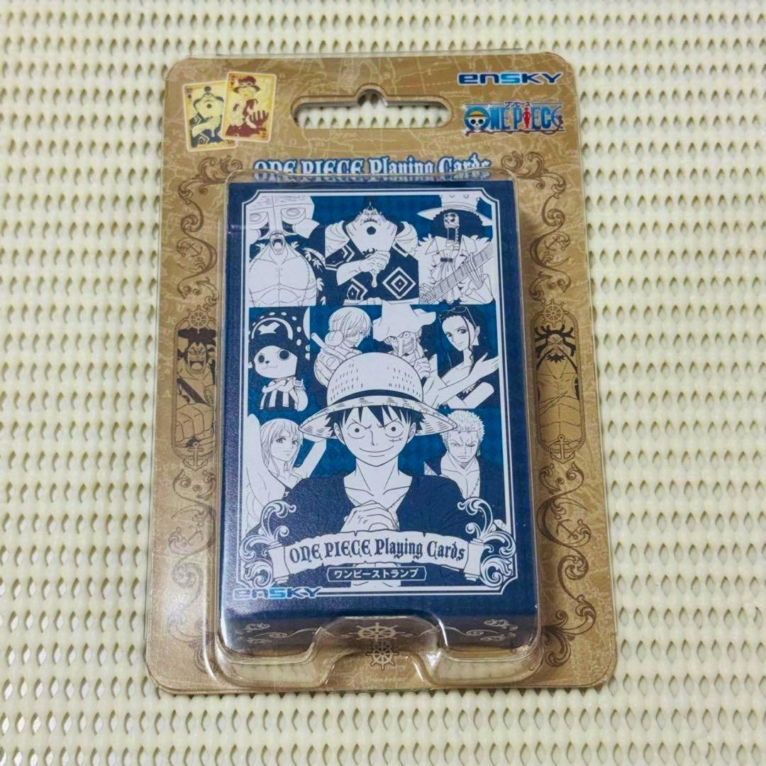 One Piece playing cards deck in blister pack showing a blue illustrated card box featuring Luffy and other characters.