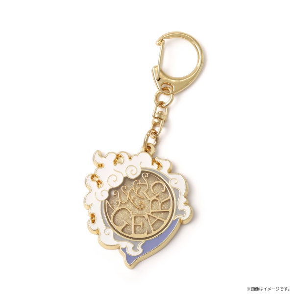 Close-up of a gold-accented keychain showing the One Piece Luffy (GEAR5) symbol motif with white cloud-like enamel and a gold clasp.