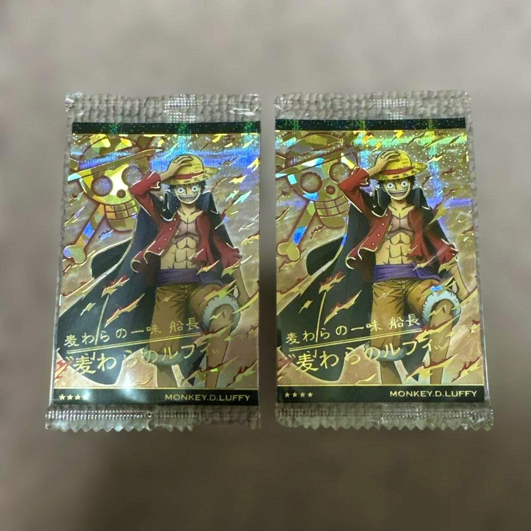 Two sealed One Piece wafer photocard packs showing holographic front artwork of Monkey D. Luffy (GR No.9-02) on a neutral background.