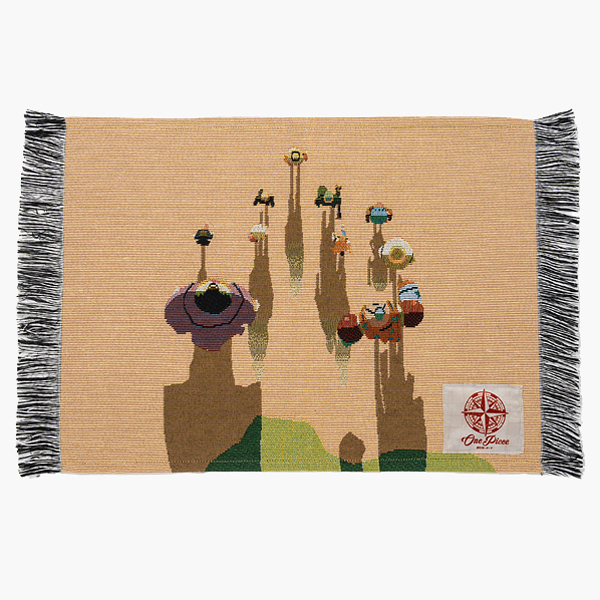 Woven polyester placemat with fringed edges and a One Piece (Egghead) woven design photographed flat on a white background.