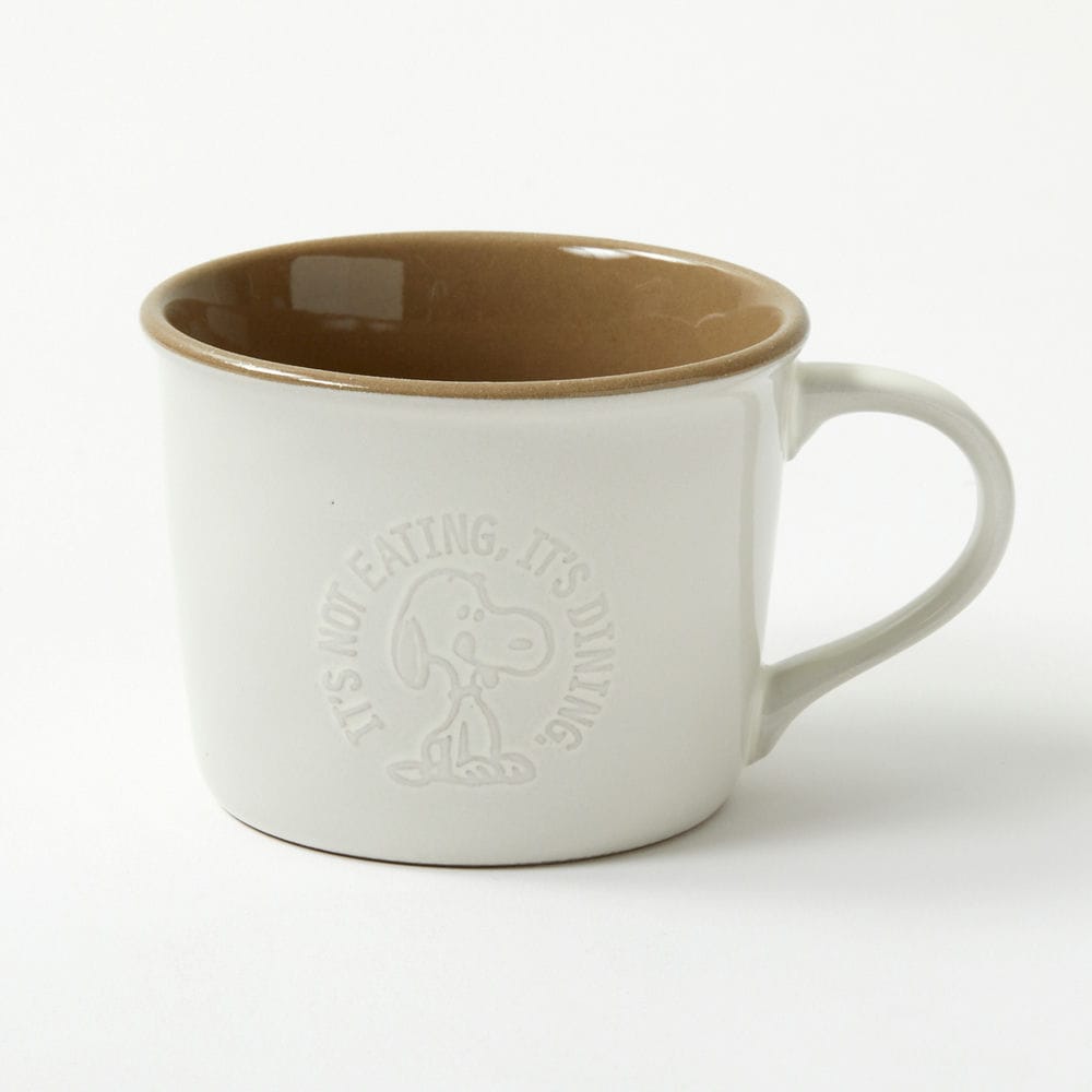 White ceramic mug with a brown interior and an embossed Snoopy design on the side.