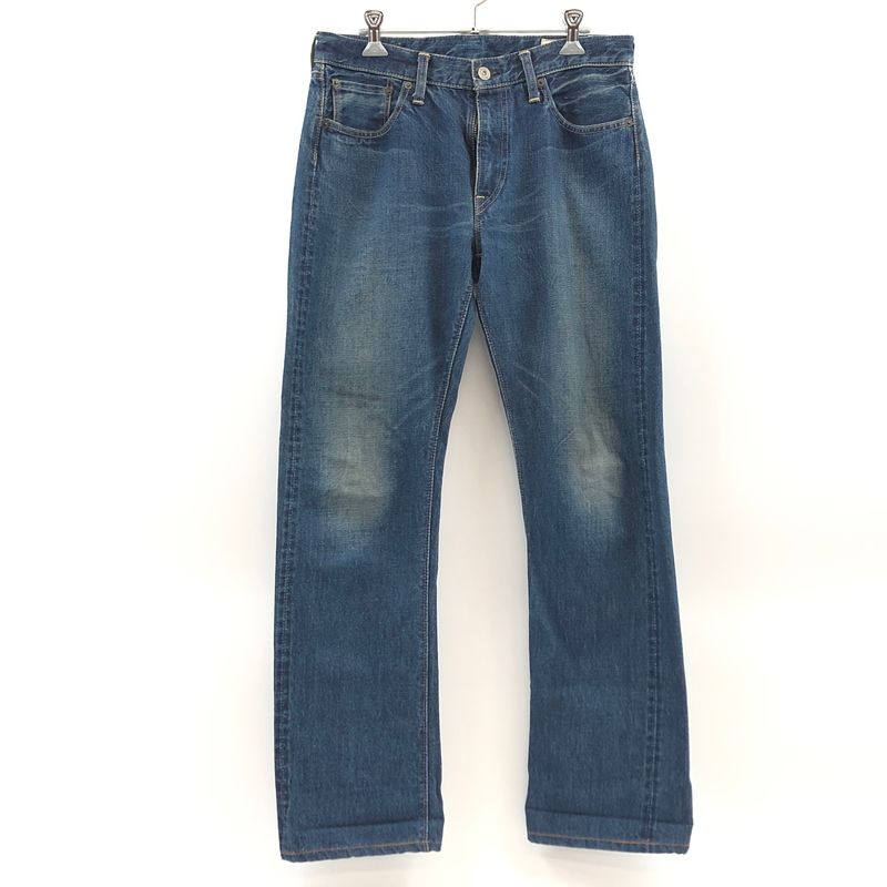 Front view of used ORSLOW straight denim men's jeans hanging against a white background.