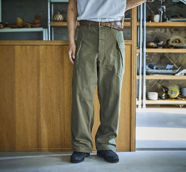 Front view of the men's 2-pocket cargo pants worn by a model, showing full-length fit and front cargo pockets.