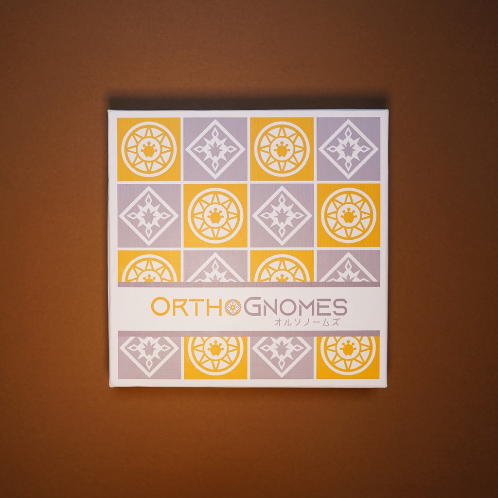 Top-down photo of the OrthoGnomes board game box showing its patterned cover.