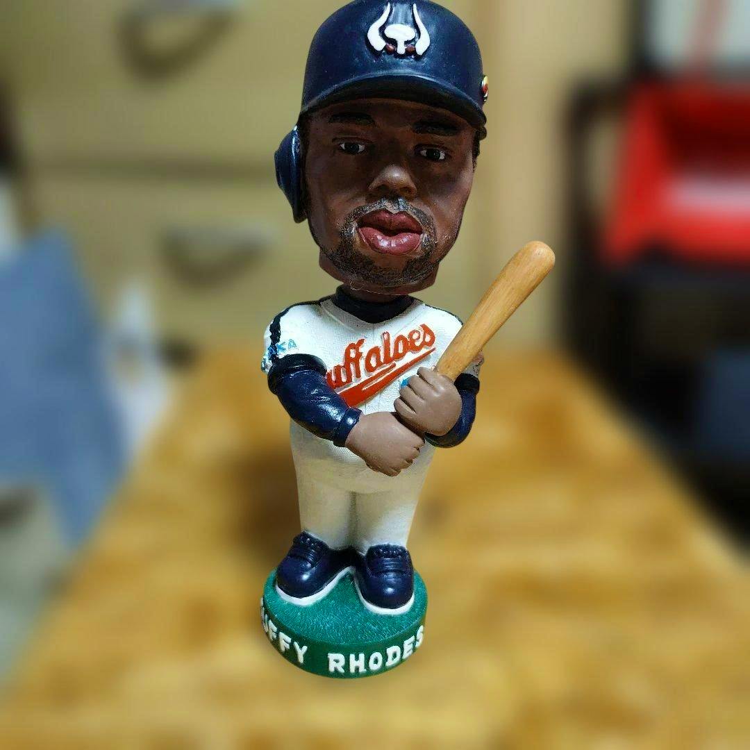 Front view of the T. Rhodes bobblehead figure in an Osaka Kintetsu Buffaloes uniform holding a baseball bat.