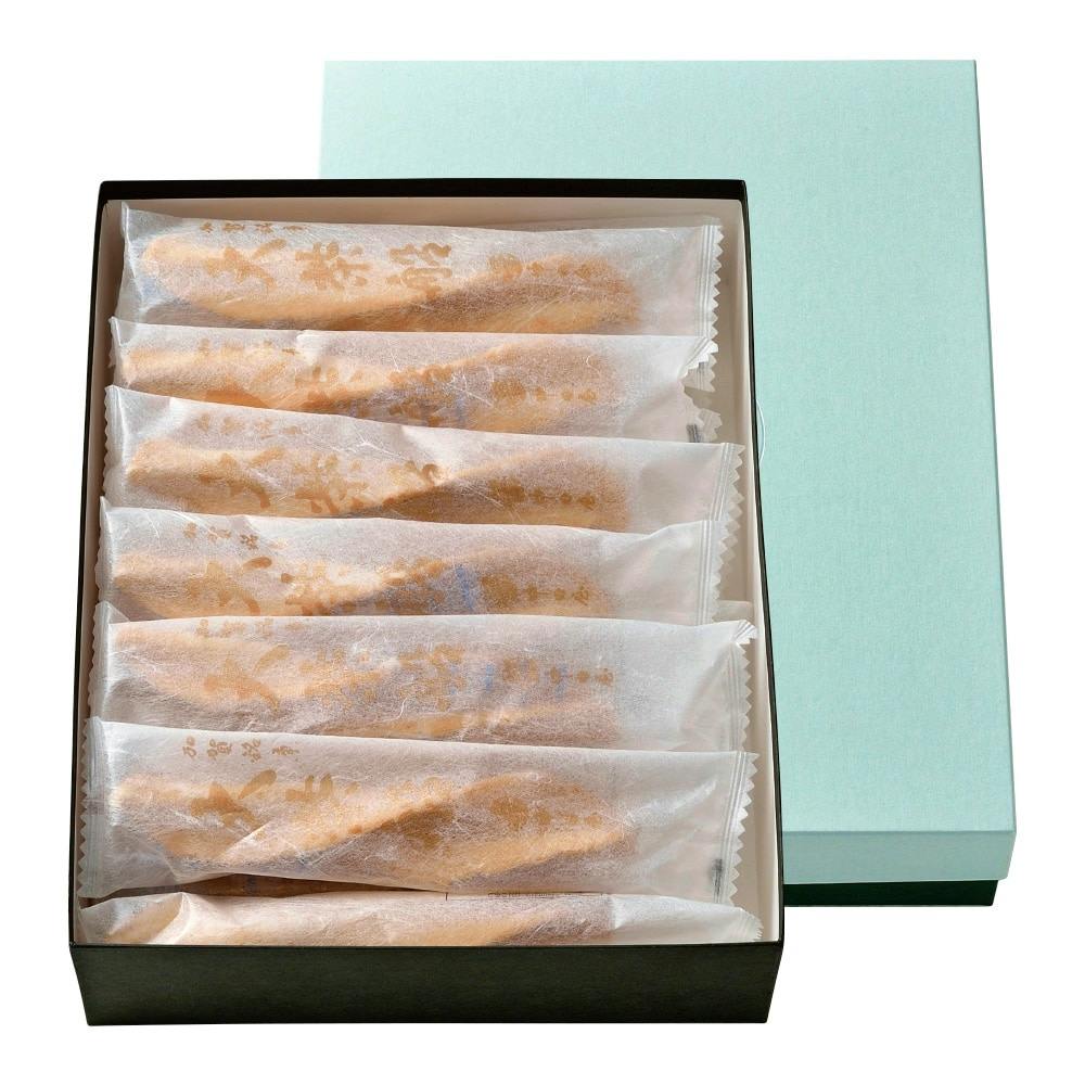 Open box showing individually wrapped cookies neatly arranged in rows with the lid partially removed.